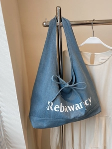 Large blue denim tote bag with bow tie and logo print for women's casual daily commute