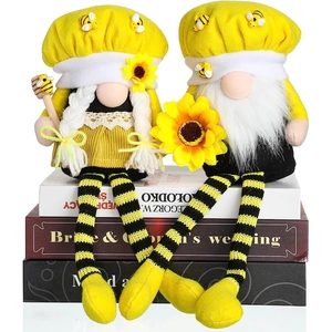 Detail of two handmade plush bee gnomes with long legs for home holiday decoration