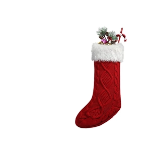 Classic red cable knit Christmas stocking with white plush cuff and festive ornaments
