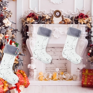 Detail of white Christmas stocking with silver tree pattern and grey faux fur cuff