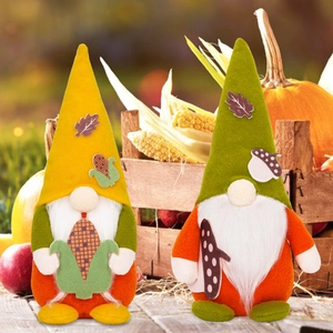 Fall themed gnome ornaments with maple leaf and corn patterns for Thanksgiving decor