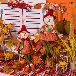 Harvest festival faceless scarecrow dolls with autumn pumpkins and maple leaf decorations