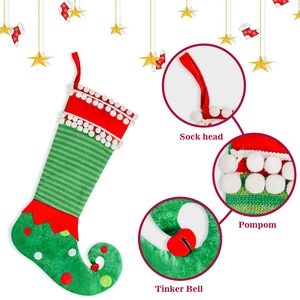 Detail of Christmas elf stocking featuring striped fabric, white pom-poms and a tinker bell