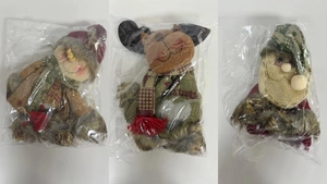 Detail of Christmas plush doll gift bags featuring Santa, elk, and snowman designs