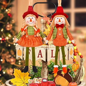 Harvest festival gnome scarecrow dolls with orange plaid outfits and FALL banner backdrop