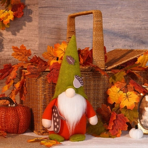 Close-up of autumn gnome plush with acorn hat and mushroom detail in harvest decor