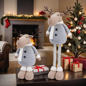 Christmas reindeer plush ornaments with retractable legs in a cozy fireplace setting