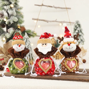 Three Christmas drawstring gift bags with heart window featuring Santa, snowman and reindeer