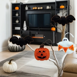 Detail of felt Halloween ornaments with bat pumpkin and ghost hanging on branches
