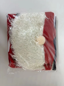 Detailed view of red Christmas toilet cover set with white beard in plastic packaging