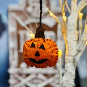 Handmade orange felt pumpkin pendant with black stitching for Halloween festive decoration