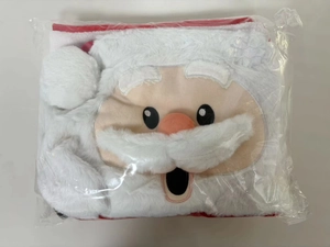 Detail of Santa Claus plush toilet cover set in clear plastic packaging