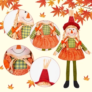 Detail of harvest scarecrow doll with burlap dress and plaid shirt for autumn decor