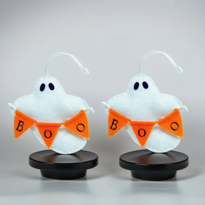 Plush white ghost Halloween hanging ornament with orange BOO banner and silk cord
