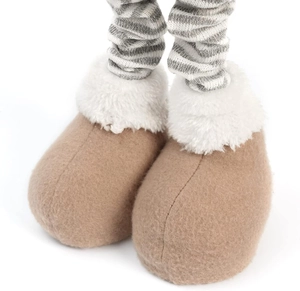 Macro detail of brown felt boots with plush white faux fur on striped reindeer legs