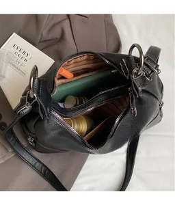 Top view of large black lychee leather bag interior with multiple zipped compartments