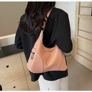 Detailed back view of a light pink leather hobo bag with pebbled texture and metal zipper
