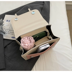 Interior view of the two-tone mini backpack showing capacity for phone and small umbrella