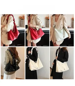Details der großen Shopper-Tasche mit gerafftem Trageriemen und glänzender Lackoberfläche