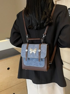 Retro mini backpack with blue denim flap and silver butterfly metal accent
