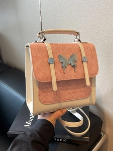 Pink and white contrast leather backpack featuring silver butterfly metal ornament