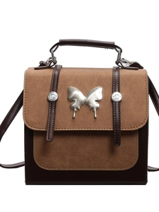Retro two-tone leather handbag with large silver metallic butterfly and stud details