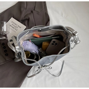 Top view showing large capacity of silver bucket bag with daily essentials inside