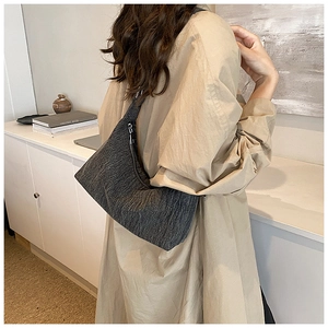 Detail shot of the textured dark grey hobo bag showing the high-density knit fabric