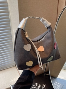 Charcoal grey hobo bag with colorful heart patches and silver tassel detail