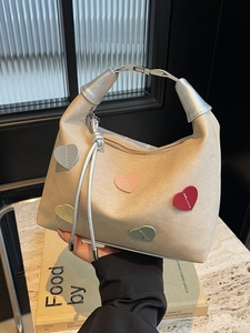 Chic beige hobo bag with multi-color 3D heart patches and silver tassel detail