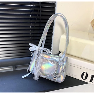 Detailed macro view of holographic Y2K shoulder bag with lace bow and heart metal pendant