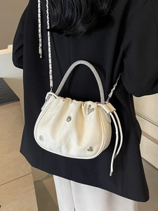 Elegant white ruched bucket bag with rhinestone handle and metal heart charms