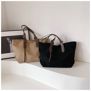 Detail of minimalist khaki and black canvas tote bags with premium leather shoulder straps