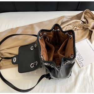 Detailed interior of black bucket backpack showing compartments and silver chain closure