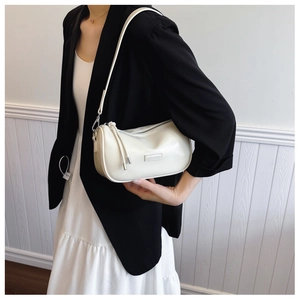 White matte PU leather half-moon shoulder bag shown on model with elegant metal zipper detail