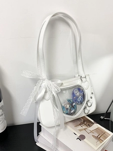 White patent leather heart-shaped ita bag with clear window and side lace bow details