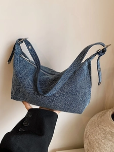 Vintage blue denim crescent shoulder bag with silver hardware for casual summer style