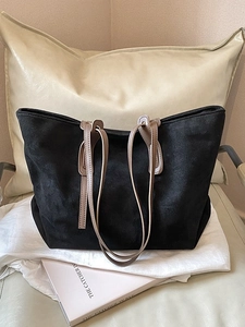 Minimalist large capacity black tote bag with brown leather straps for commuting