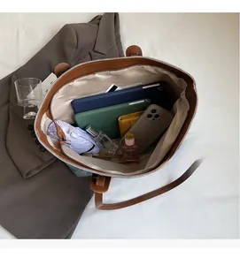 Top view of blue denim tote bag interior showing large capacity and internal pockets