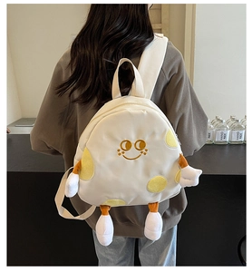 Detailed back view of a white canvas cartoon backpack with 3D plush arms and legs