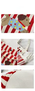 Détail du sac seau en toile à rayures rouges avec broderie chien et bouton pression