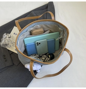 Top view of large capacity denim tote bag showing interior storage for tablets and gadgets