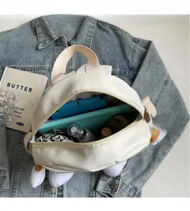 Internal view of cream canvas backpack showing large capacity for tablets and cosmetics