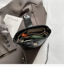 Interior view of black quilted chain bucket bag showing daily essentials storage