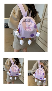 Detail of cute purple cartoon backpack with 3D plush arms and legs for students