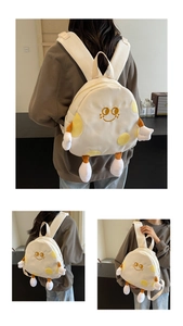 Detail of cute cartoon backpack with yellow polka dots and plush 3D creative limbs