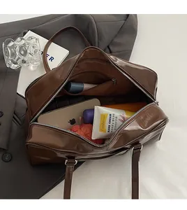 Detailed view of the brown leather Boston bag spacious interior with a zippered pocket