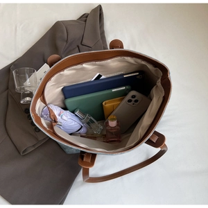 Macro shot of large capacity tote bag interior showing multi-pocket storage capacity