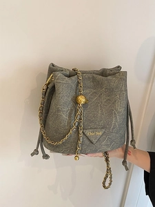 Grey marble texture drawstring bucket bag with gold chain strap and metal logo