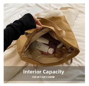 Internal view of khaki nylon tote bag showing spacious capacity and inner pockets
